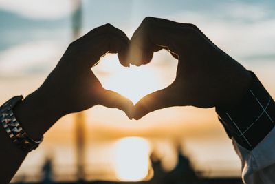 hands coming together to make a heart