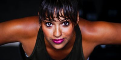 women looking into camera in black tank top